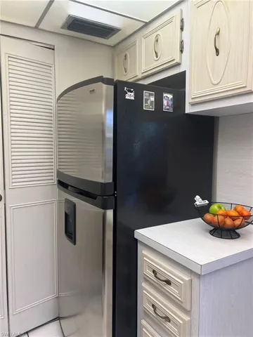 Kitchen with tile patterned flooring and stainless steel refrigerator