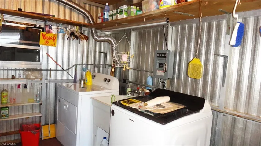 Laundry room featuring washer and clothes dryer and new electric panel