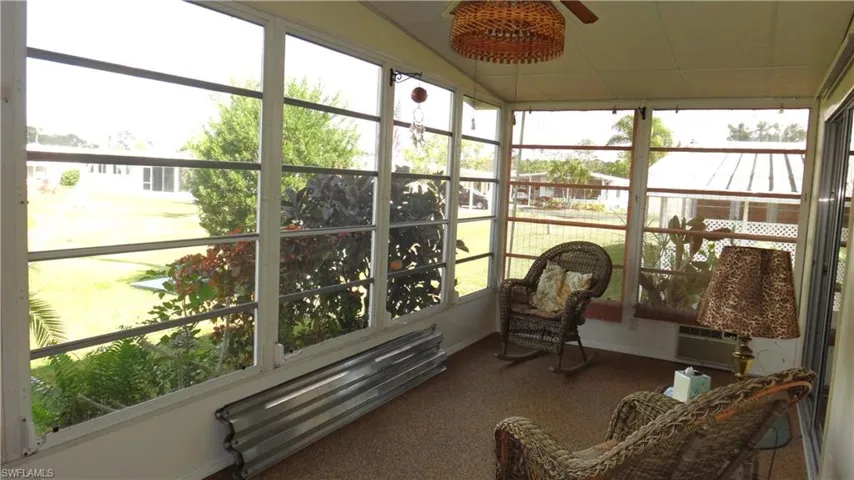 Sunroom featuring a wealth of natural light and ceiling fan