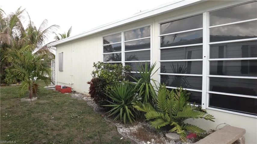 View of west side of property featuring a yard