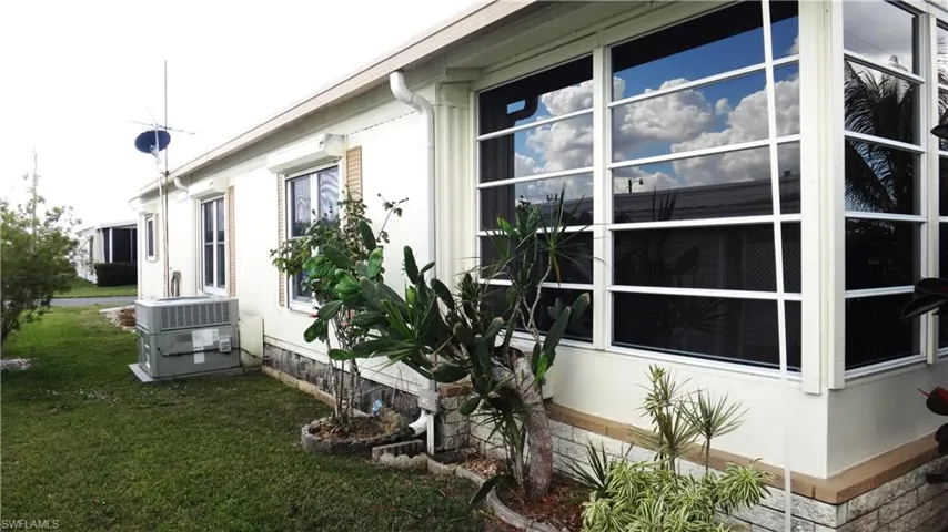 View of property exterior with air conditioner unit