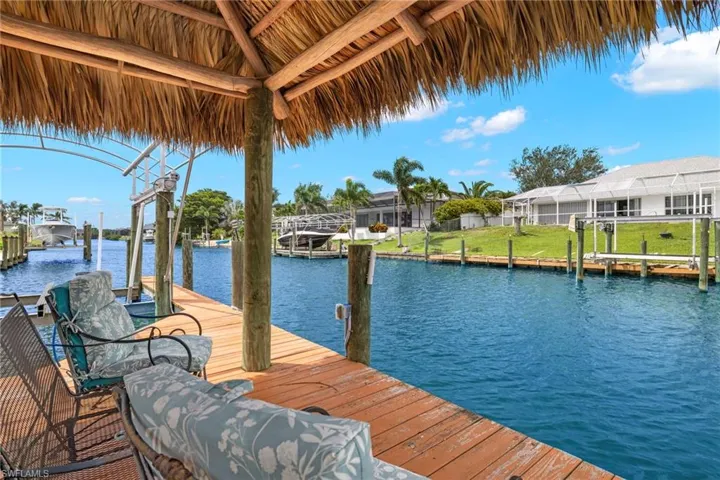 Dock area with a water view and boat lift