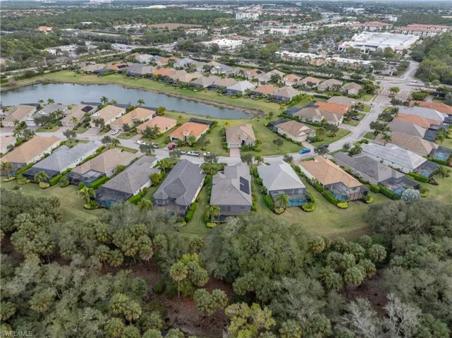 Aerial view of property and surrounding area with a large body of water