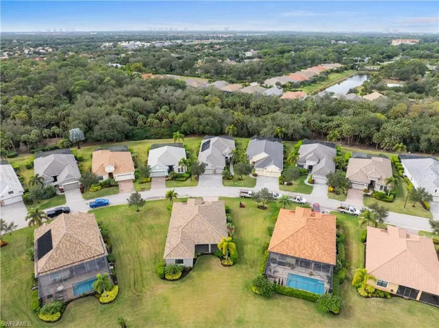 Aerial perspective of suburban area featuring a large body of water