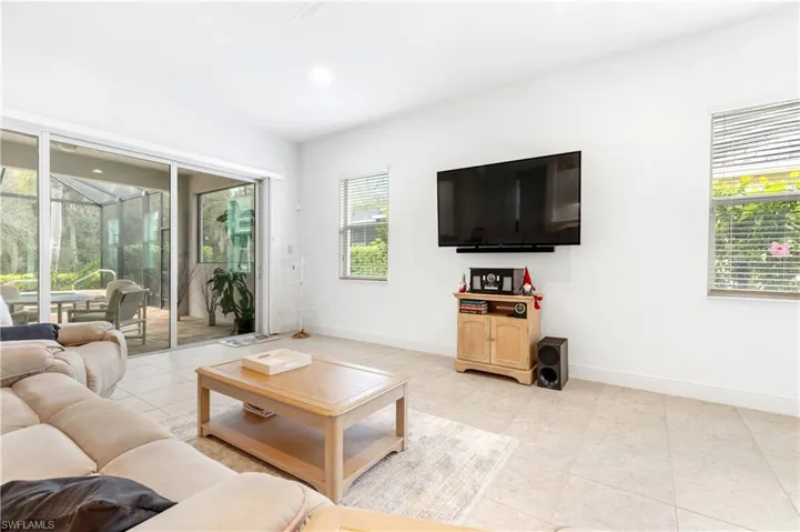 Living area with a sunroom and light tile patterned flooring