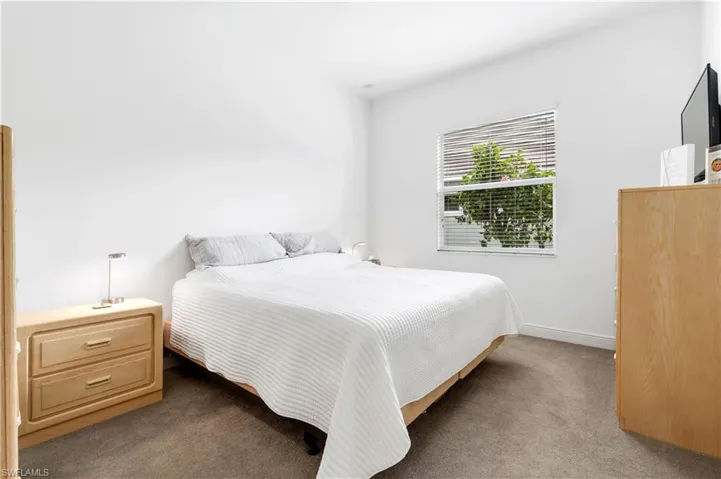 Bedroom featuring carpet floors and baseboards