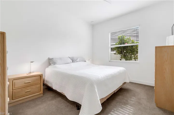 Carpeted bedroom with baseboards