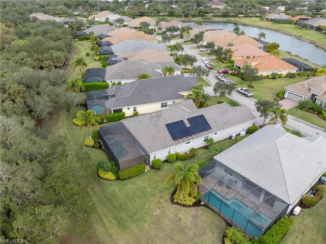 Aerial view of residential area featuring a nearby body of water