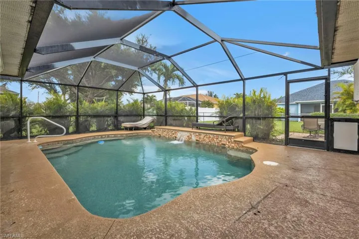 View of pool with pool water feature, a patio, and a lanai