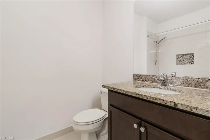 Bathroom with vanity and a shower