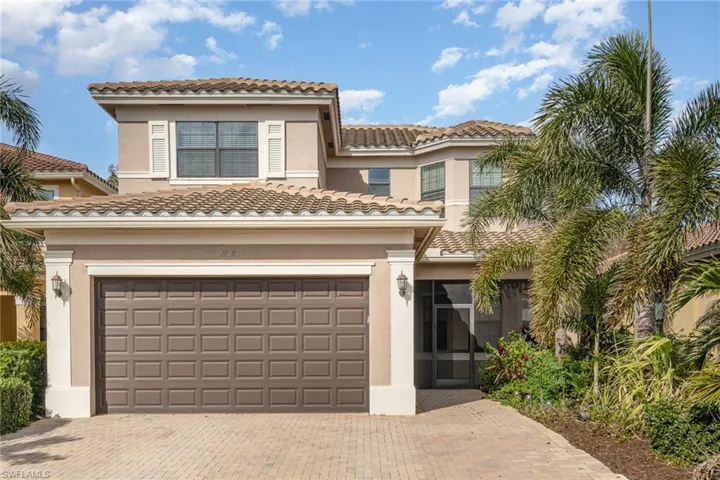 Mediterranean / spanish house with a tiled roof, stucco siding, decorative driveway, and a garage