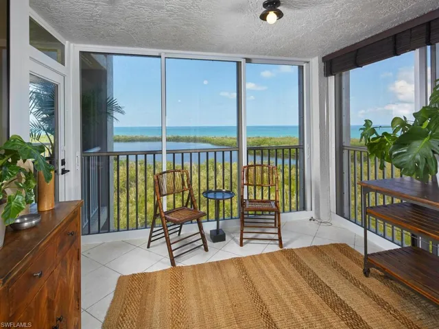Sunroom / solarium with a water view