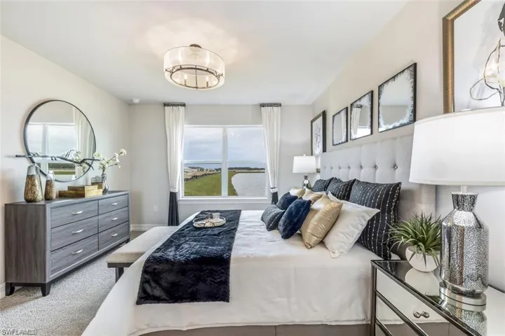Bedroom with carpet and a chandelier