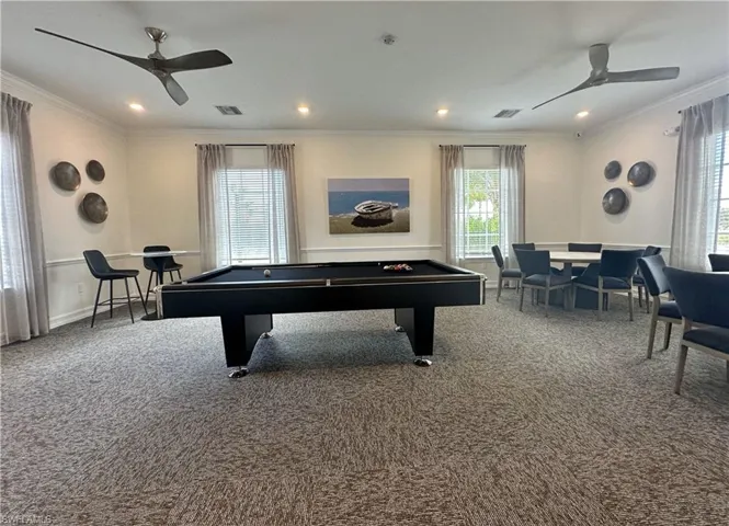 Playroom with pool table, crown molding, carpet flooring, and ceiling fan