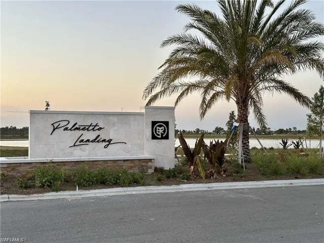 Community / neighborhood sign with a water view
