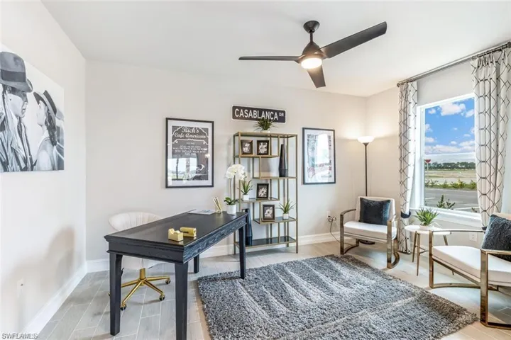 Office space with wood-type flooring and ceiling fan