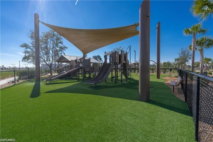 View of jungle gym featuring a lawn