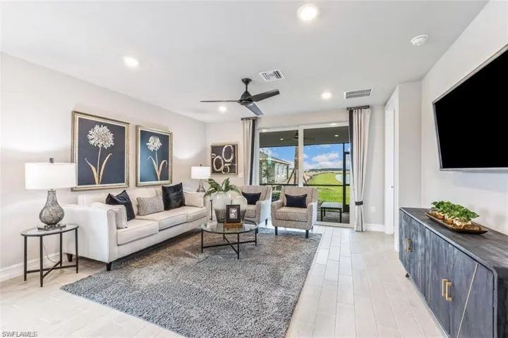 Living room featuring light hardwood / wood-style flooring and ceiling fan