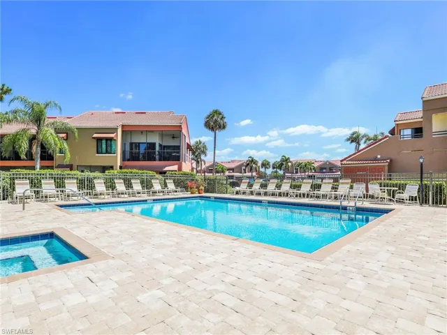 View of swimming pool featuring a patio and a hot tub
