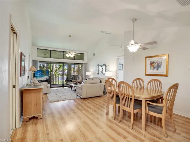 Dining area featuring light hardwood / wood-style flooring, ceiling fan, and vaulted ceiling