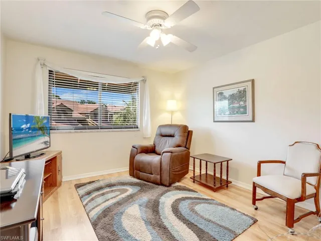 Sitting room featuring light wood-type flooring and ceiling fan