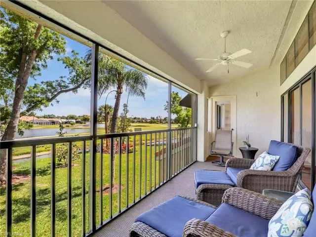 Sunroom featuring a water view and ceiling fan