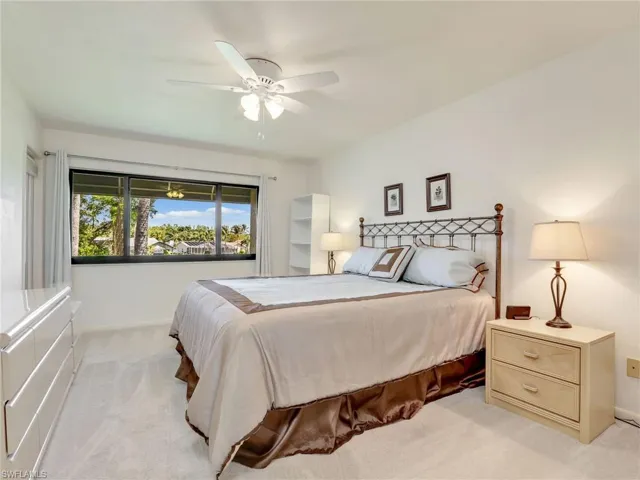 Bedroom featuring light colored carpet and ceiling fan