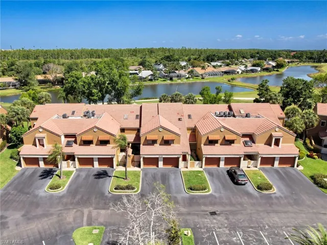 Birds eye view of property with a water view