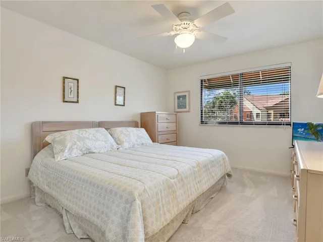 Carpeted bedroom with ceiling fan