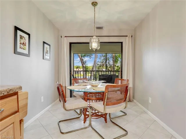 Dining area featuring an inviting chandelier and light tile patterned flooring