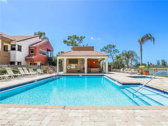 View of swimming pool featuring a patio and a community hot tub