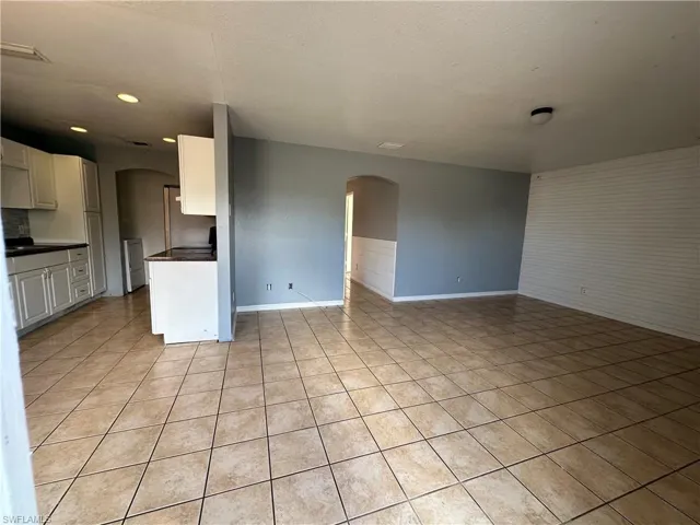 Kitchen featuring white cabinets and light tile patterned flooring