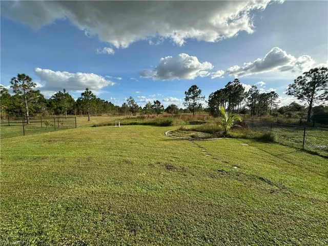 View of yard with a rural view