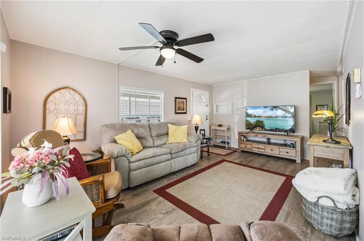 Living room with wood finished floors and a ceiling fan