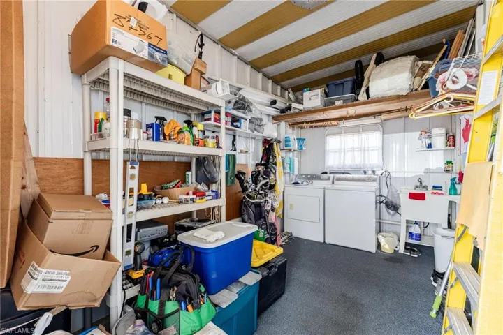 U-shed featuring independent washer and dryer and a sink