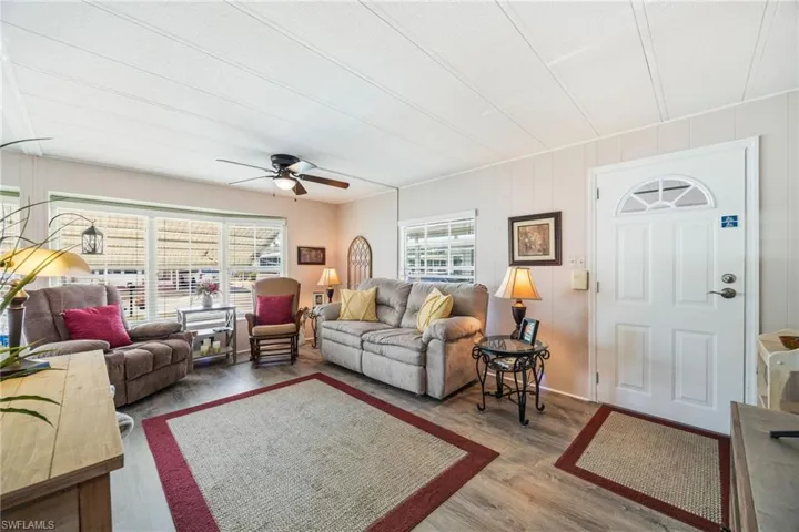 Living area with wood finished floors and a ceiling fan