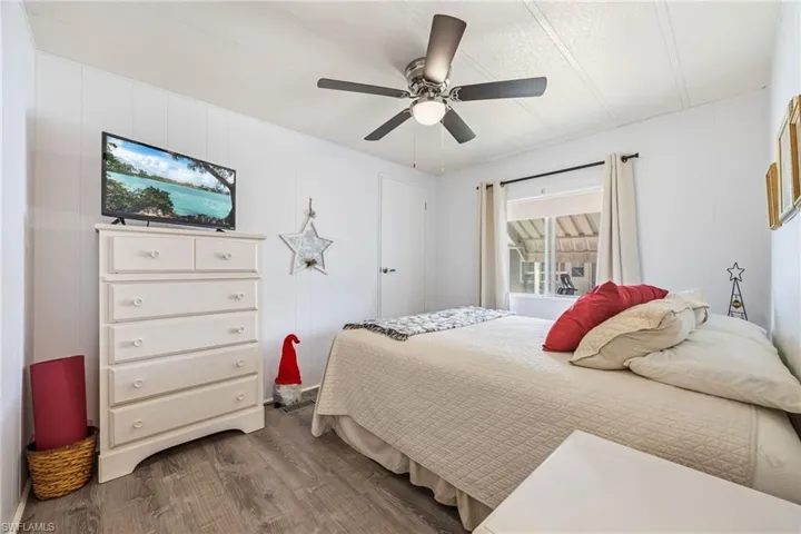 Bedroom with dark wood finished floors and a ceiling fan