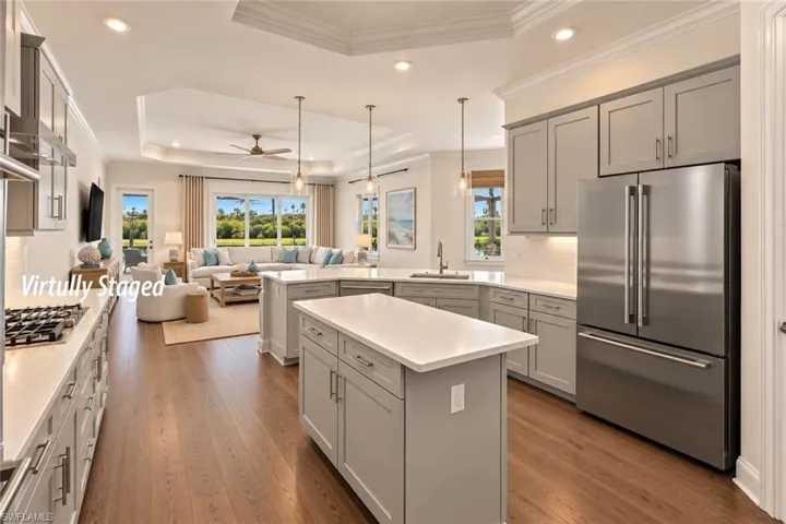 KITCHEN FEATURES ABUNDANT CABINETRY, STAINLESS STEEL APPLIANCES, GAS COUNTER TOP STOVE.  PANTRY IS AT THE FAR RIGHT OF THE PHOTO.