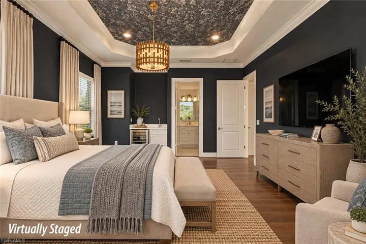 BONUS ROOM STAGED AS A GUEST ROOM.  BEVERAGE COOLER AND SINK AT REAR.  ENTRANCE TO A BATH SHOWN AT MIDDLE REAR.