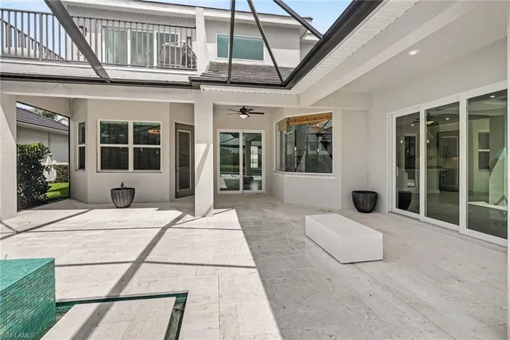 REAR VIEW:  FAR LEFT SHOWS THE 3 WINDOWS AND THE OUTDOOR LIVING DOOR TO THE PRIMARY SUITE.  MIDDLE REAR ARE THE SLIDING DOORS TO THE LIVING AREA.  THE CANTED WINDOWS ARE WHERE THE BREAKFAST NOOK IS.  THE 3-PANEL SLIDING DOORS LEAD TO THE FAMILY ROOM.