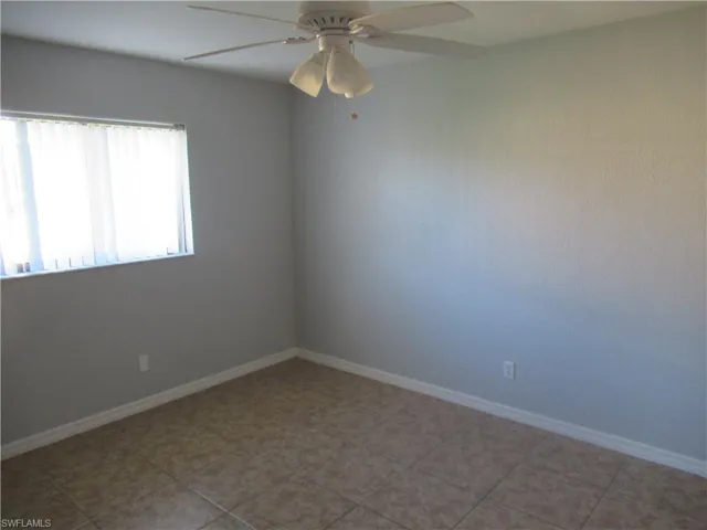 Spare room featuring tile patterned floors and ceiling fan