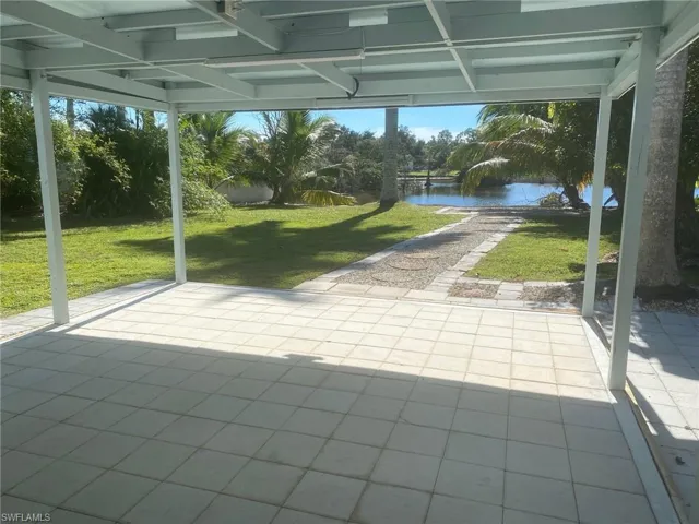 Unfurnished sunroom featuring a water view