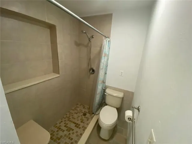 Bedroom featuring wood finished floors, a ceiling fan, and a closet