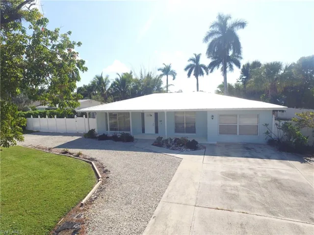 Single story home with driveway and stucco siding