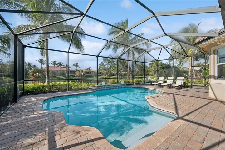 View of swimming pool with a lanai and a patio