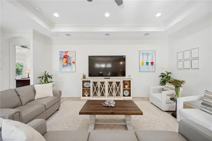 Living room with ceiling fan and crown molding
