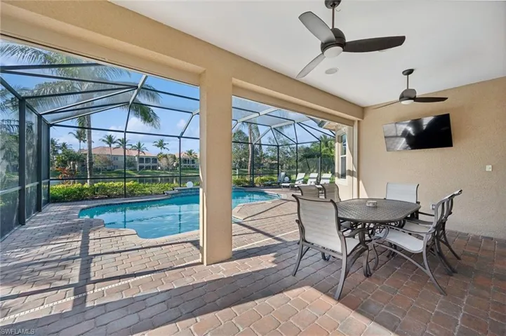 View of pool featuring ceiling fan, a lanai, and a patio