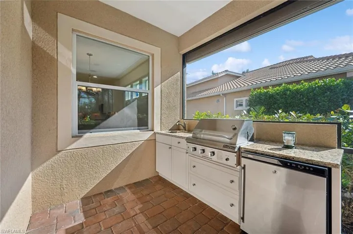 View of patio featuring sink, an outdoor kitchen, and a grill