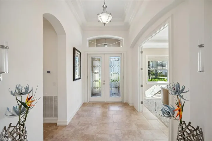 Entryway with french doors and ornamental molding