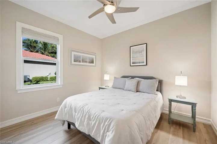 Bedroom with hardwood / wood-style flooring, ceiling fan, and crown molding